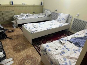 Three simple hostel beds next to each other